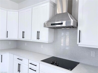 Kitchen featuring black electric cooktop, wall chi