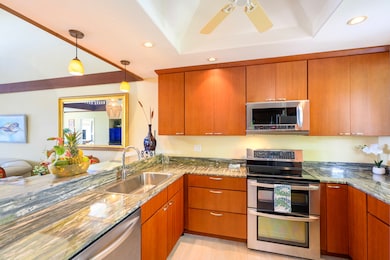 The updated kitchen has high-end stainless steel appliances, designer cabinets and gleaming granite countertops