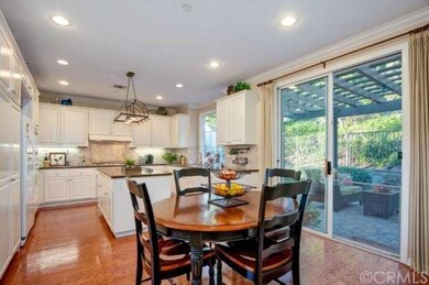 Gourmet kitchen with granite counters opens to a s