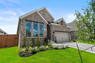 View of front of home featuring brick siding, dri