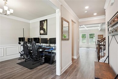 Office area featuring crown molding, wood finished floors, a chandelier, recessed lighting, and coffered ceiling