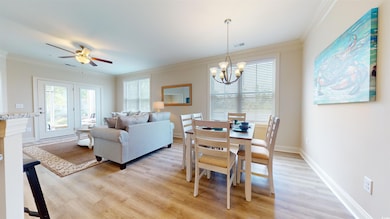 Dining space featuring ceiling fan with notable ch