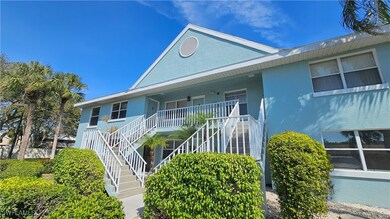 View of front of house featuring stairway, covered
