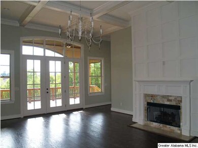 The living room features a coffered ceiling and co