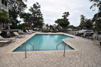 Community pool with a patio