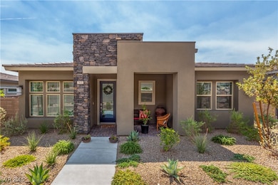 View of front of house featuring stucco siding and stone siding