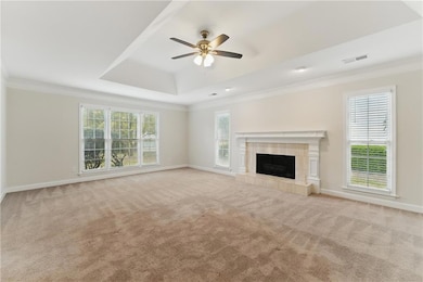 Unfurnished living room with light carpet, baseboa