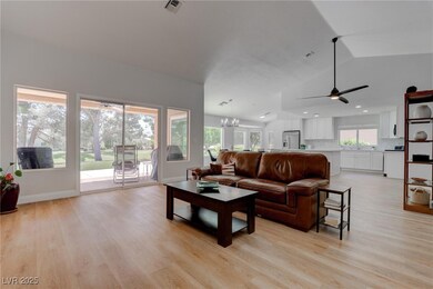 Living room with light wood finished floors, ceili