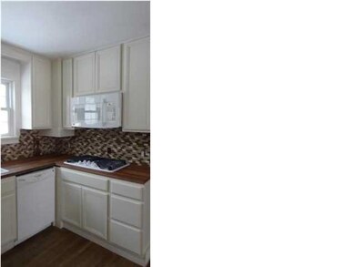Kitchen features new cabinets and hard wood floors