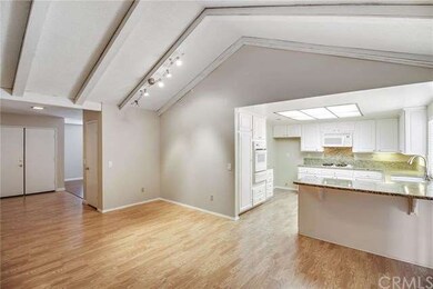 Laminated wood floors, family room with vaulted ce