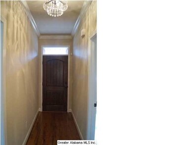 Entry foyer with hardwood floors, transom window o