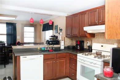 Kitchen with breakfast bar, open to dining room, u