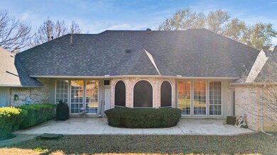 Rear view of property with roof with shingles, a p