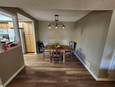 Dining area with visible vents, a textured ceiling