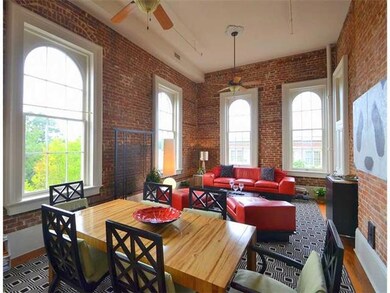 Living Room. Great room features exposed brick wal