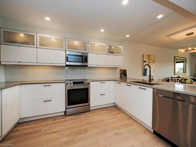 Lit glass, soft-close cabinetry, gorgeous tile bac