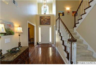 Stunning 2-story foyer with hardwood flooring