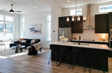 Kitchen with a center island with sink, stainless 
