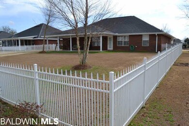 Lifetime aluminum fence encloses back yard and sto