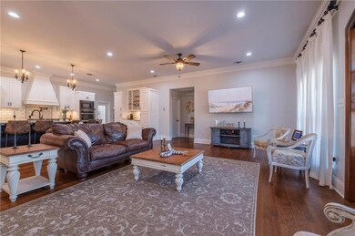 Living room featuring crown molding, dark hardwood