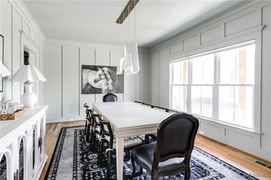 Light-filled dining space with light wood flooring