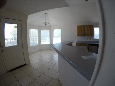 Kitchen with a chandelier, pendant lighting, stainless steel dishwasher, and a wealth of natural light