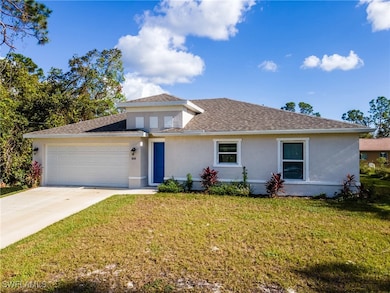 View of front of home with stucco siding, an attac