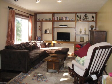 Wide, wood-planked floor and freshly painted great room.