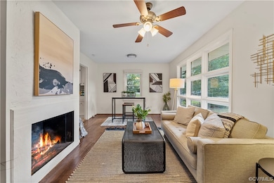 Hardwood floored living room with a fireplace and