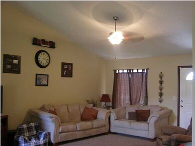 Living room with vaulted ceiling and ceiling fan