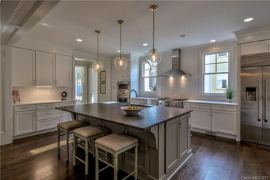 Gourmet kitchen with island, stainless hood, beaut