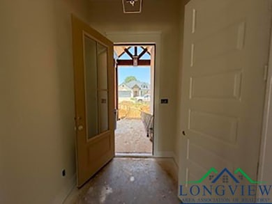 Doorway featuring baseboards