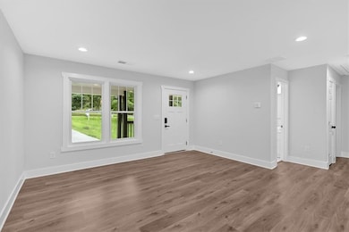 Entrance foyer featuring baseboards, wood finished floors, and recessed lighting