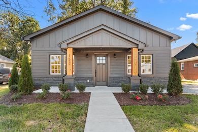 Lovely covered porch with lighting and cedar trim.
