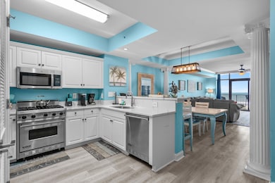 Kitchen featuring stainless steel appliances, a si