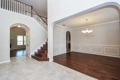 Spacious entryway with elegant wood staircase and