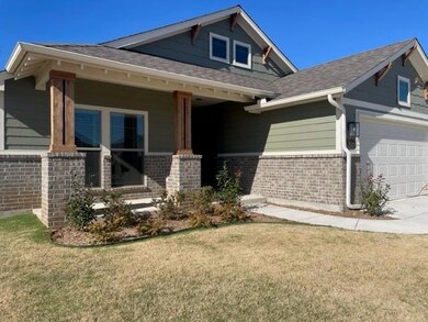 Craftsman-style house with brick siding, a front y