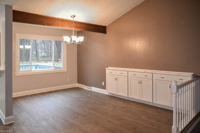 Formal dining room with a wood beam and deep built