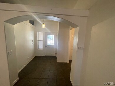 Entryway with dark tile patterned flooring