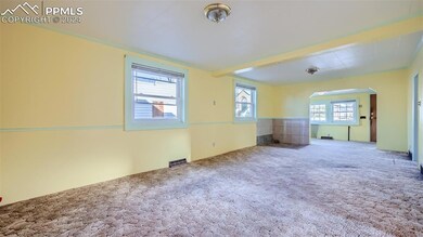 Empty room featuring light carpet