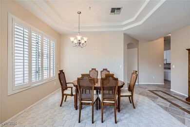 Dining space featuring a raised ceiling, visible v
