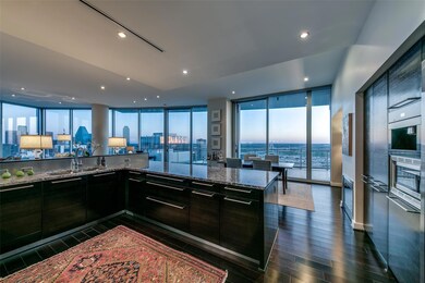 Kitchen with dark stone counters, dark hardwood / 