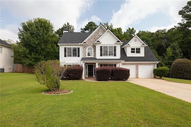 View of front of house featuring stone siding, driveway, a chimney, a shingled roof, and a porch