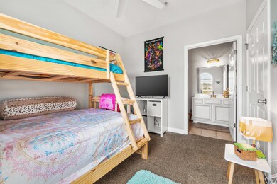 Bedroom with connected bathroom, light colored car