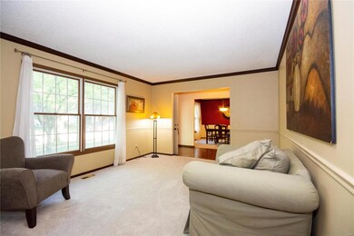 Formal living room w/newer carpeting, chair rail a