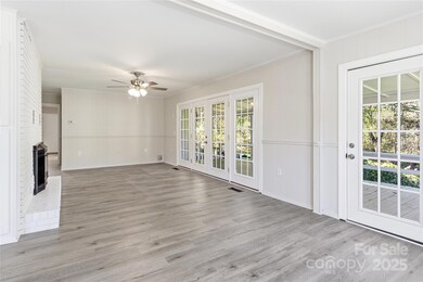 Living room and fireplace from other angle - windows everywhere!