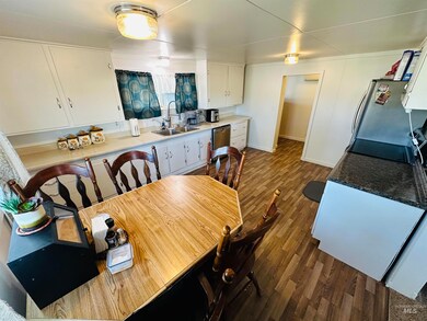 Dining area with dark wood-type flooring and baseboards