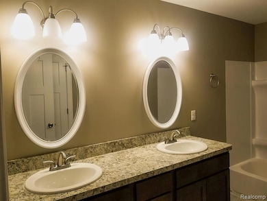 Bathroom with double vanity and shower / tub combination