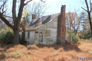 View of property exterior with a chimney and oil tank
