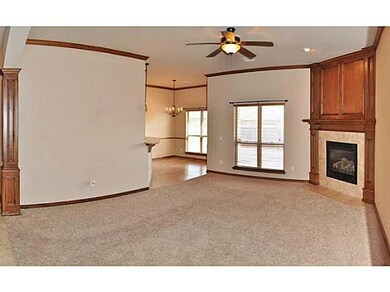 Living Room. Rich wood pillars lead to this grand 